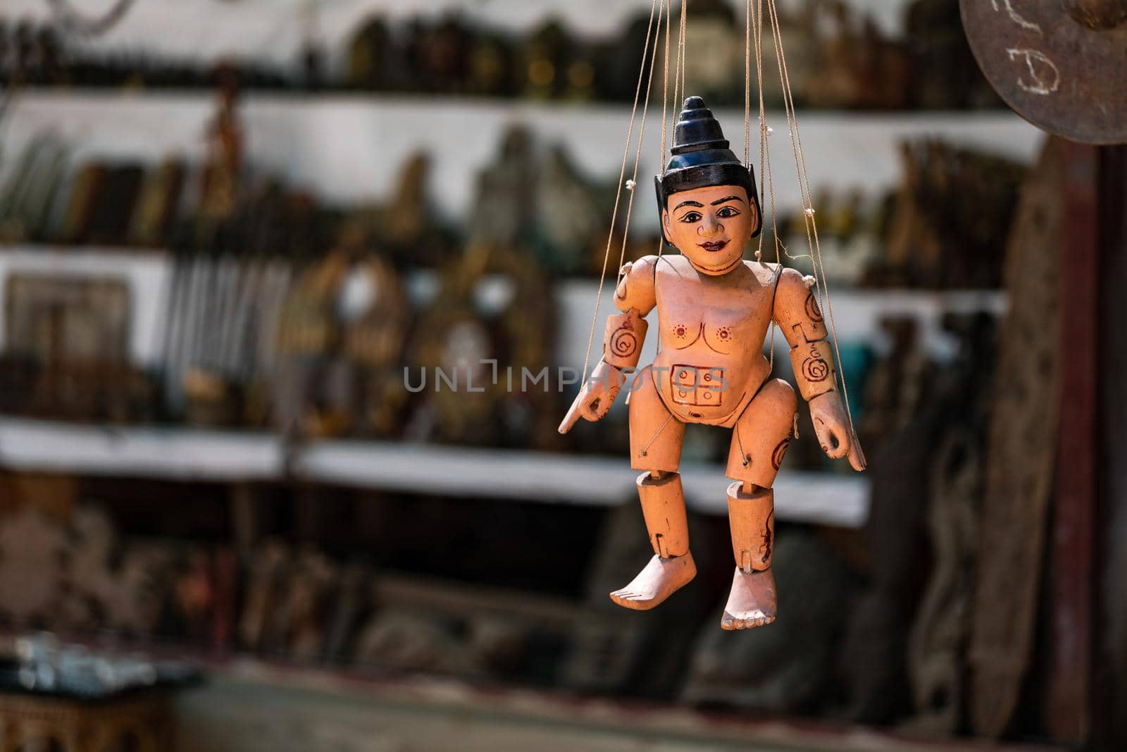Close-up of a wooden puppet with threads and simple paint in Myanmar