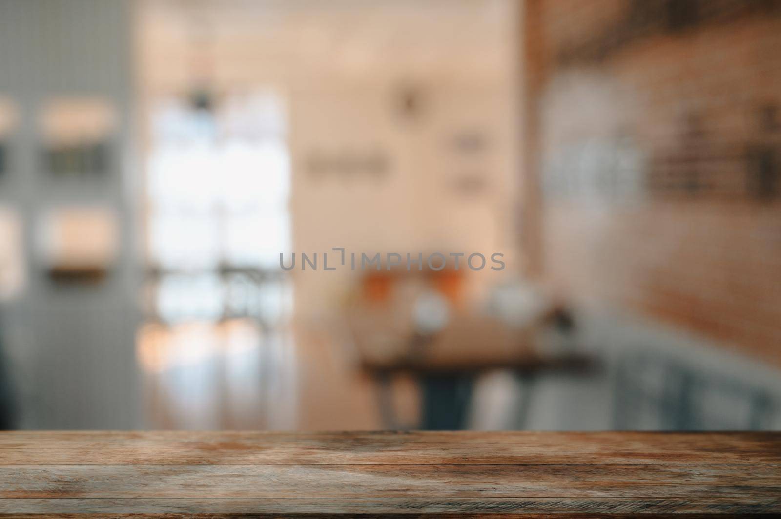 Empty wooden table with blurred coffee shop in background. For display or montage your products. by prathanchorruangsak