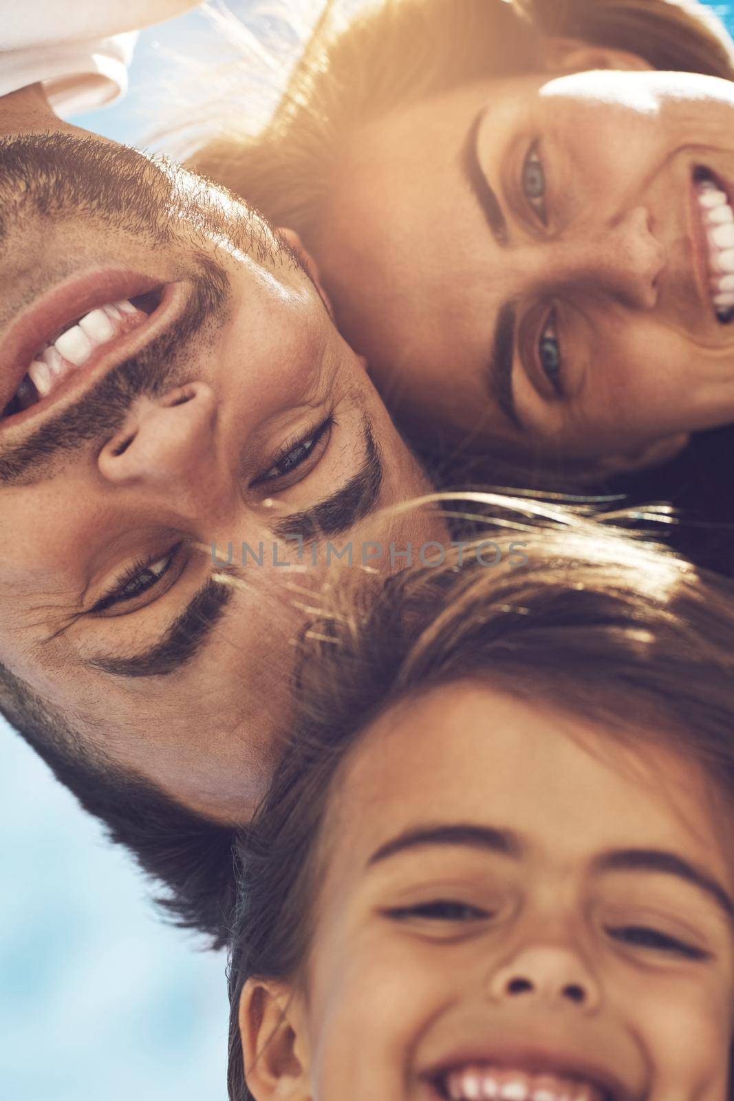 Family is everything. Low angle portrait of a happy young family enjoying their day at the beach