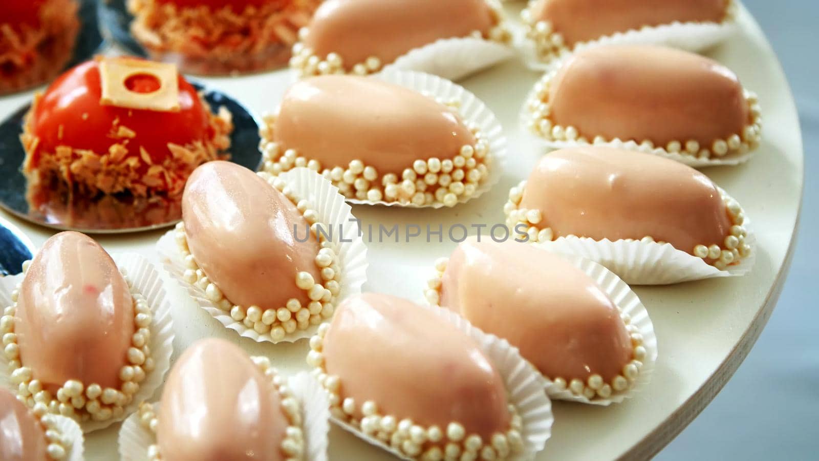 close-up, a variety of delicious desserts, cakes under the icing. festive decor, sweet bar, confectionery masterpieces, treats. High quality photo