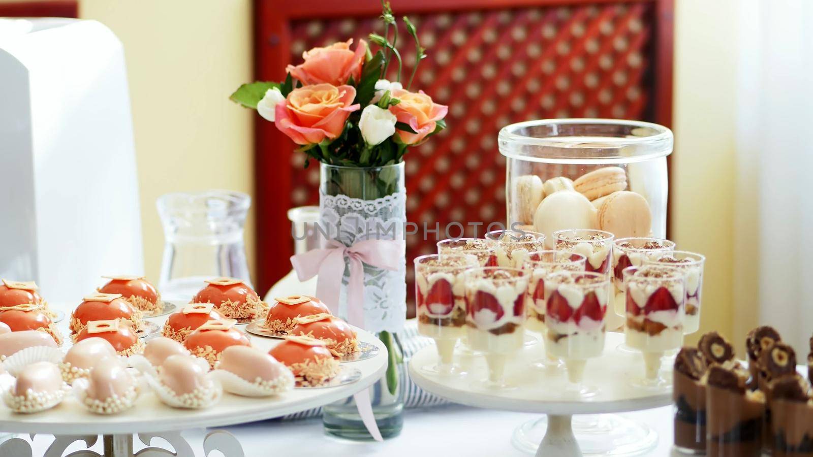 close-up, a variety of delicious desserts, cakes with cream, strawberries, chocolate, under icing , whipped cream, marshmallows, festive decor, sweet bar, corner, a treat. High quality photo