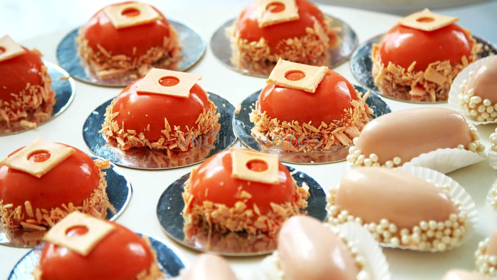 close-up, a variety of delicious desserts, cakes under the icing. festive decor, sweet bar, confectionery masterpieces, treats. High quality photo