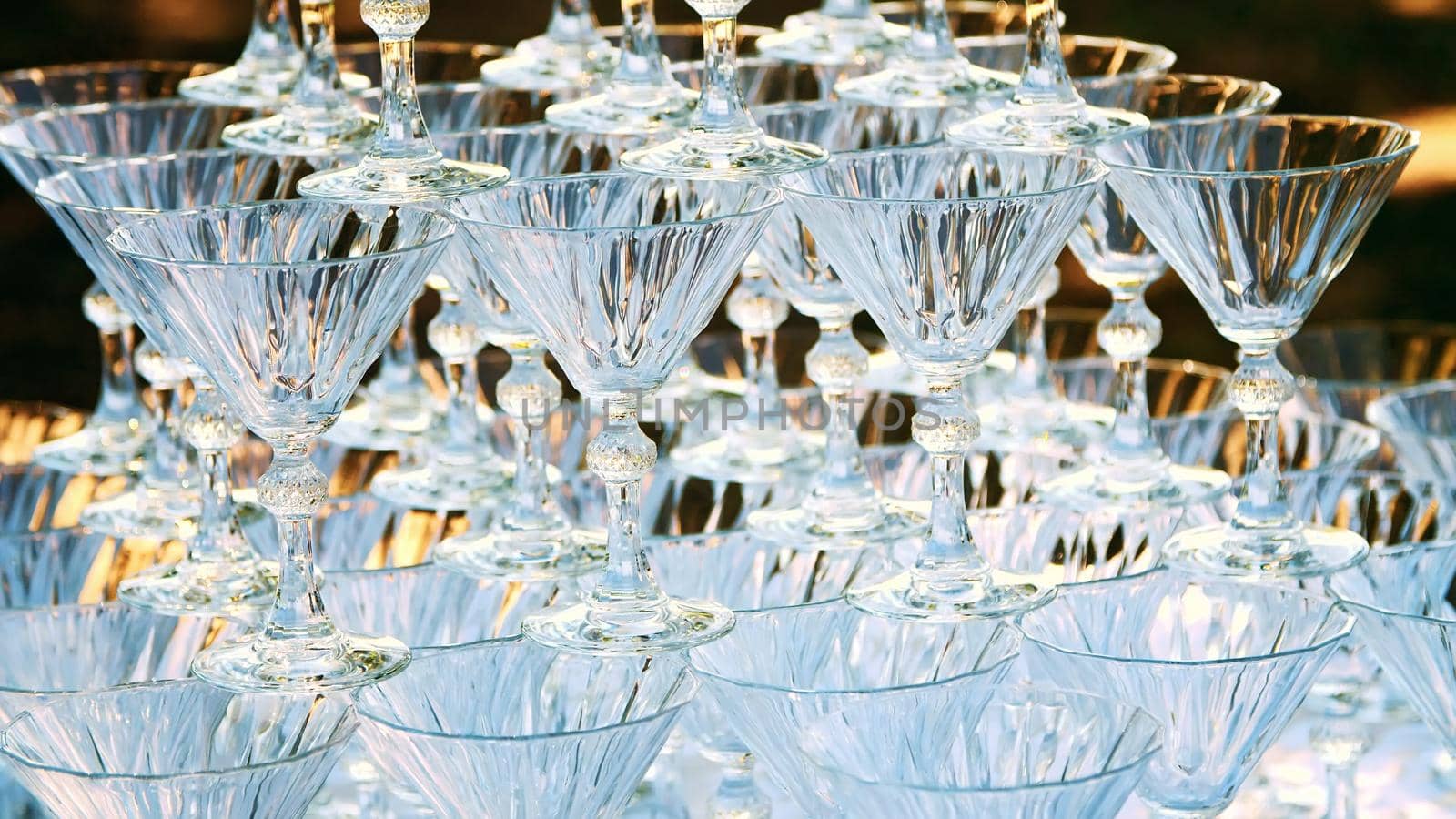 close-up, crystal champagne glasses stand on a hill, on each other, for a waterfall of champagne. High quality photo