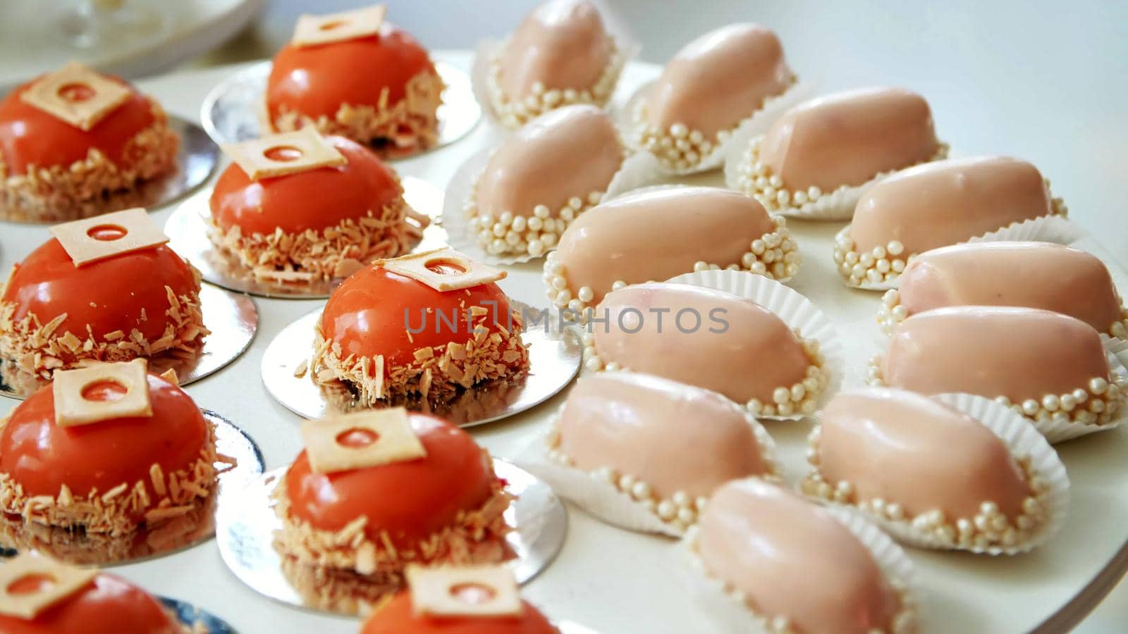 close-up, a variety of delicious desserts, cakes under the icing. festive decor, sweet bar, confectionery masterpieces, treats. High quality photo