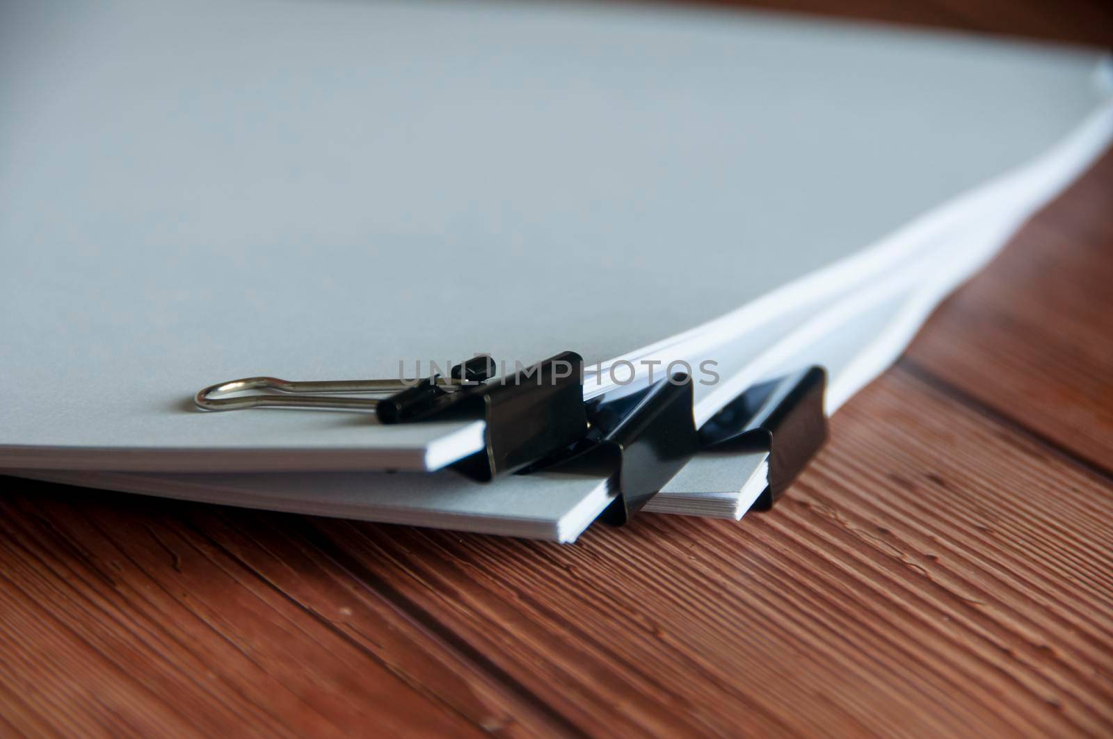 Paper stack of pile of documents on wooden desk. Copy space and business offices concept.