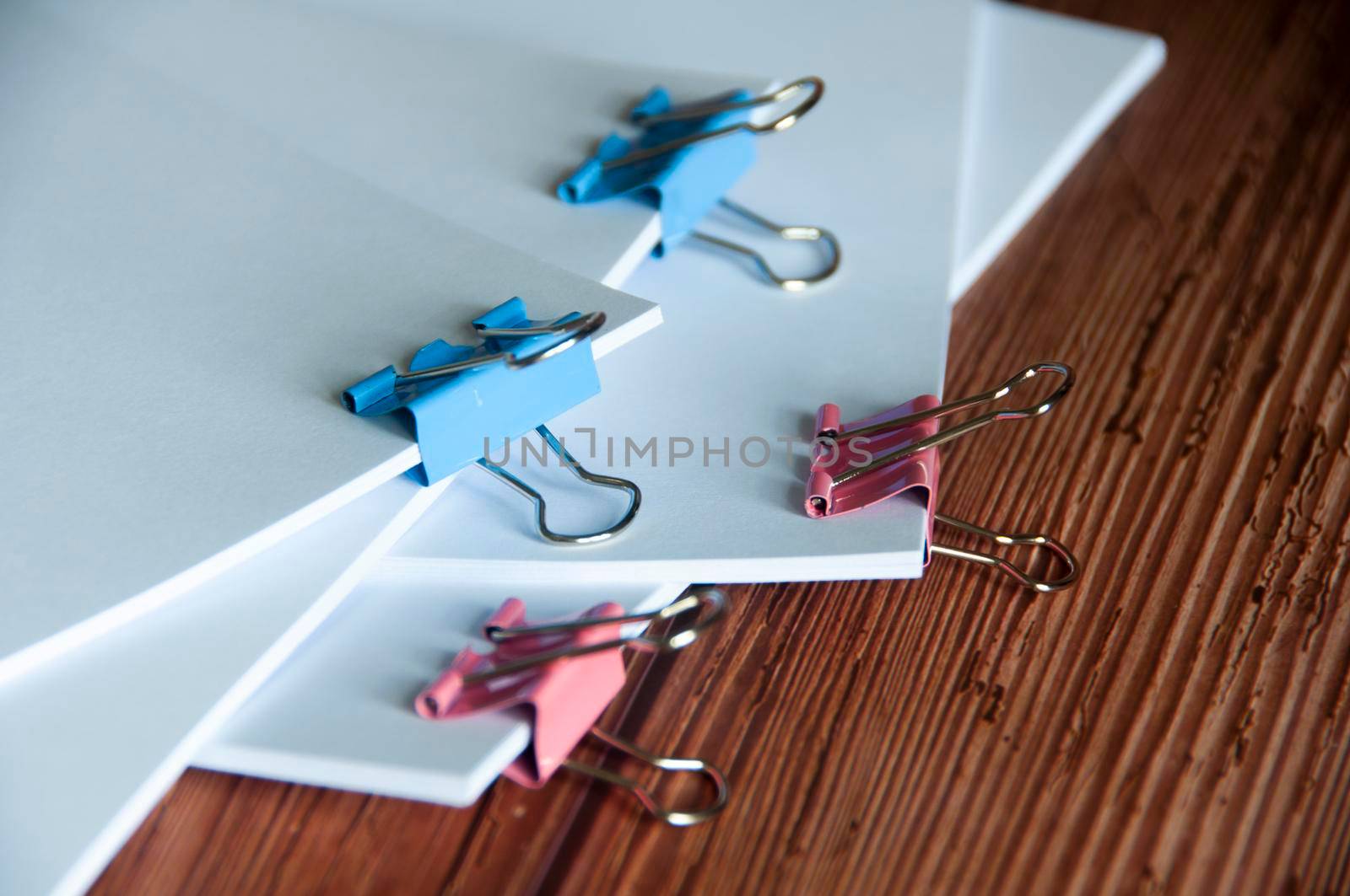 Paper stack of pile of documents on wooden desk. Copy space and business offices concept.