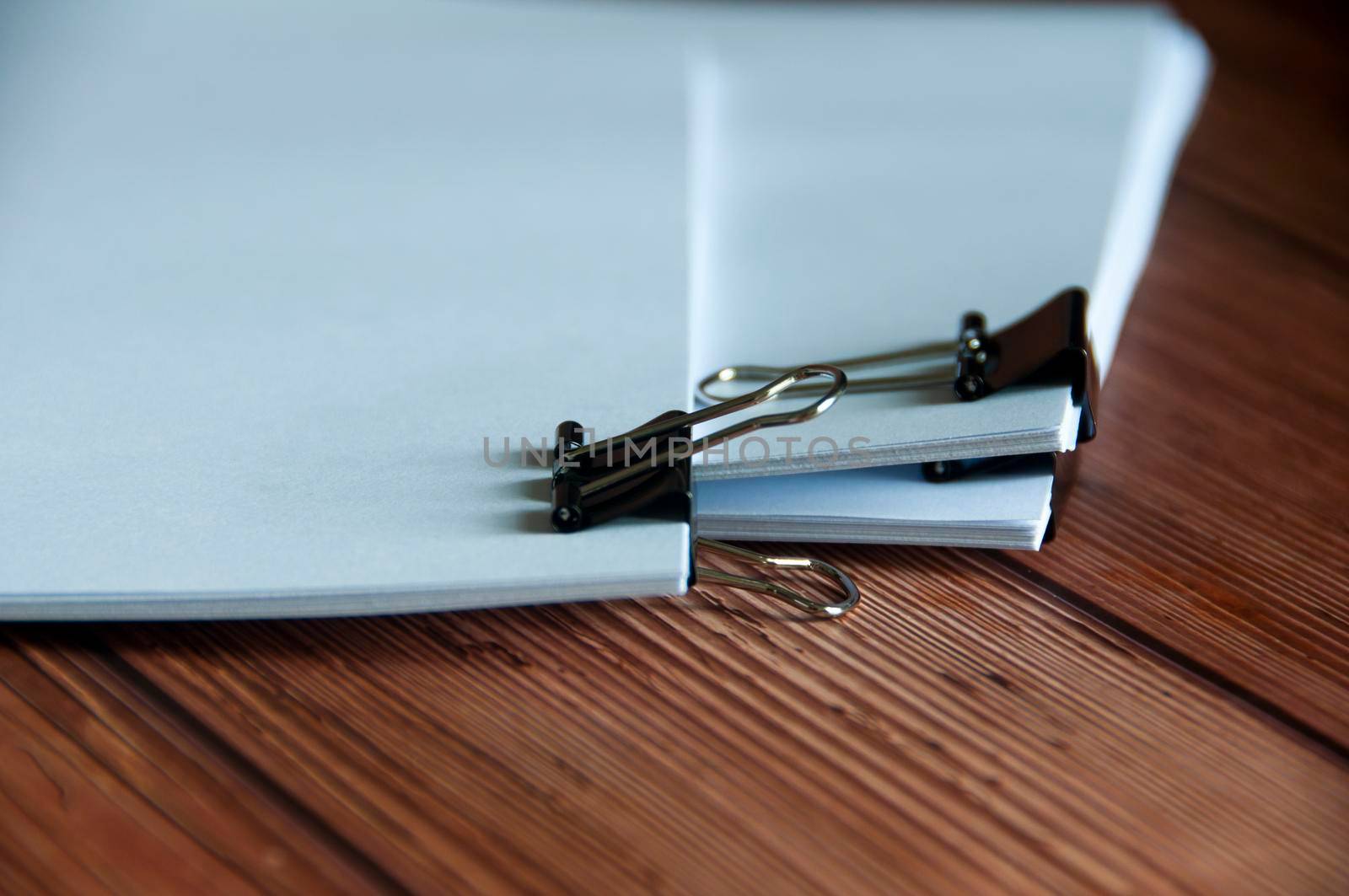 Paper stack of pile of documents on wooden desk. Copy space and business offices concept.