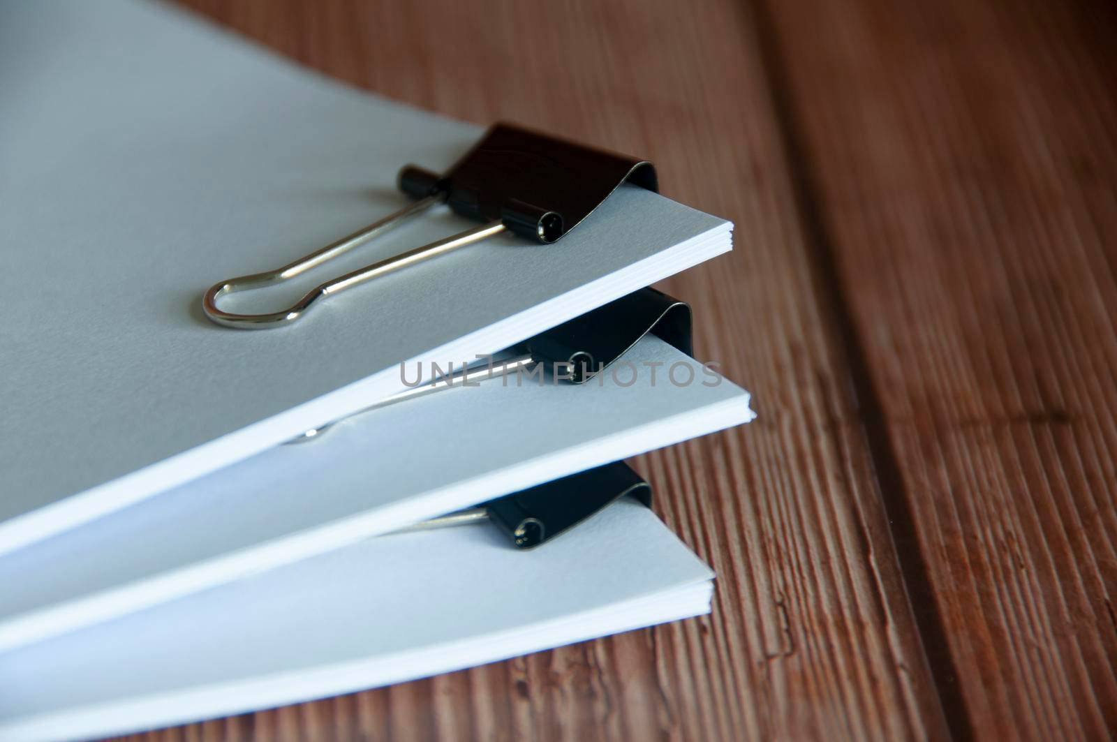 Paper stack of pile of documents on wooden desk. Copy space and business offices concept.