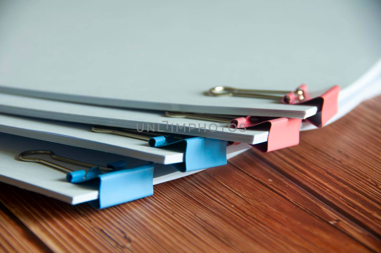 Paper stack of pile of documents on wooden desk. Copy space and business offices concept.