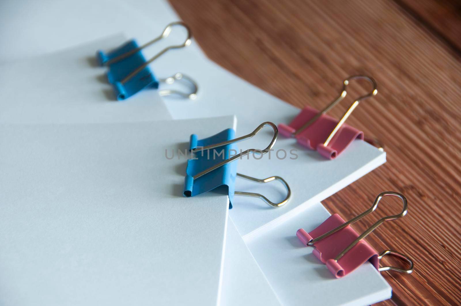 Paper stack of pile of documents on wooden desk. Copy space and business offices concept.