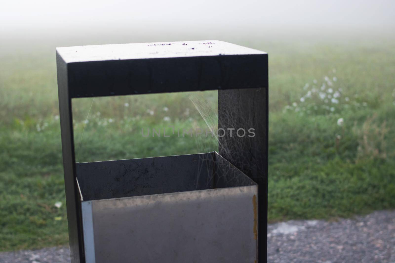 Street trash can in the park closeup in autumn