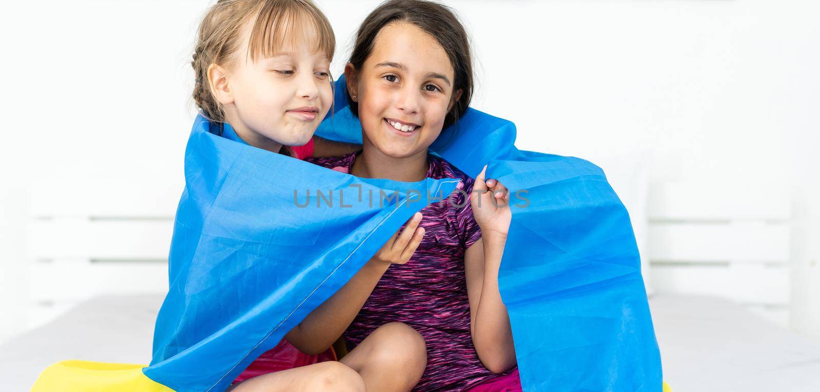 education, school, art and happiness concept - little children with the flag of ukraine.