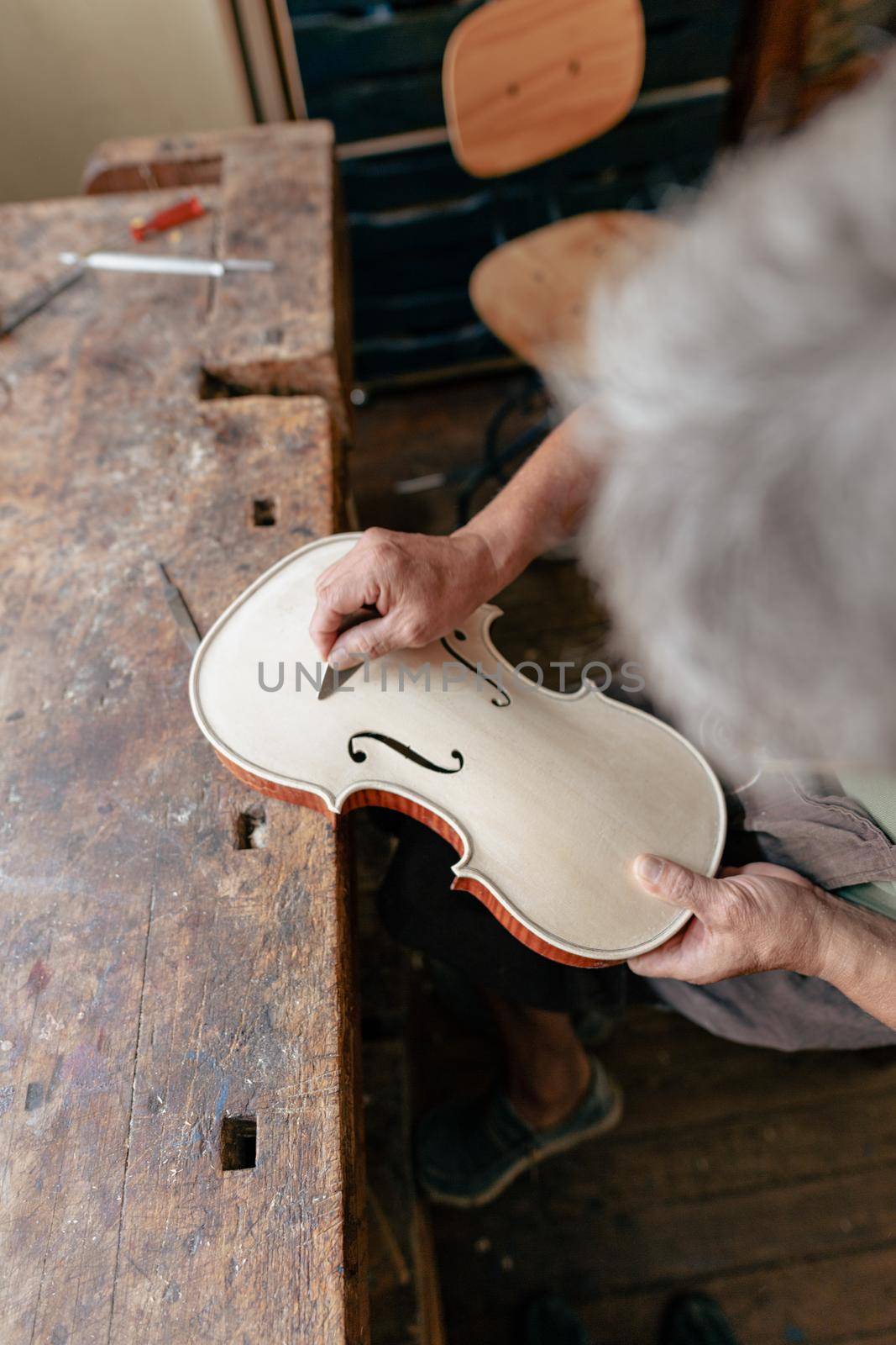 violinmaker at work in his italian workshop