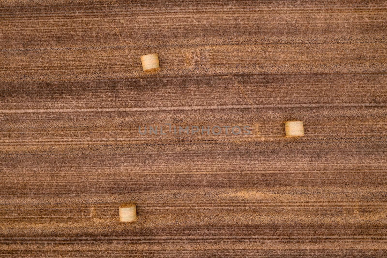 Aerial view of straw bales in a field after harvest in summer