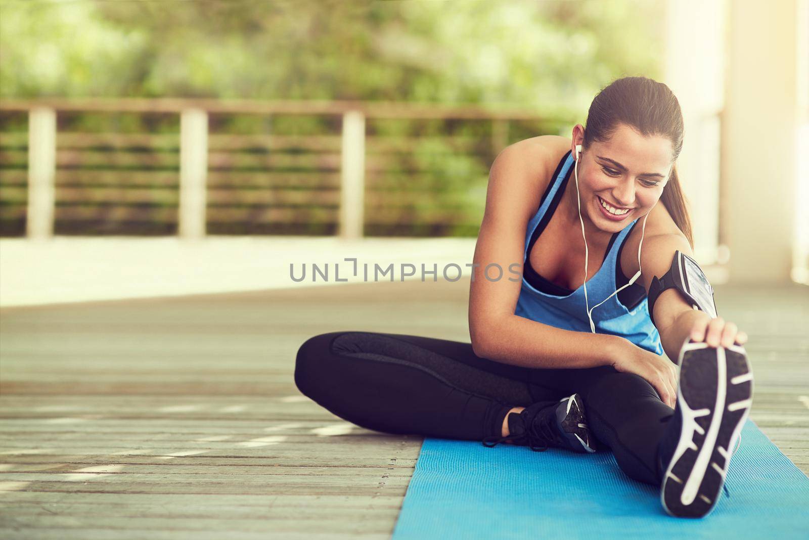 Dont forget to stretch. an attractive young woman working out