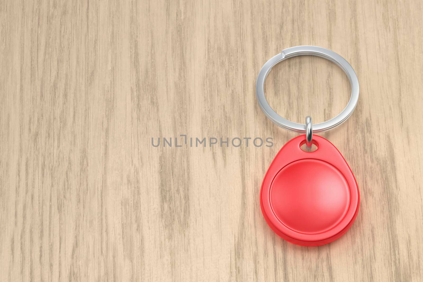 Red NFC key fob on the wooden desk