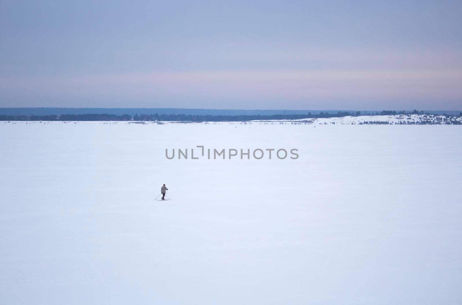 Skier on Great Russian River Volga in the Winter.