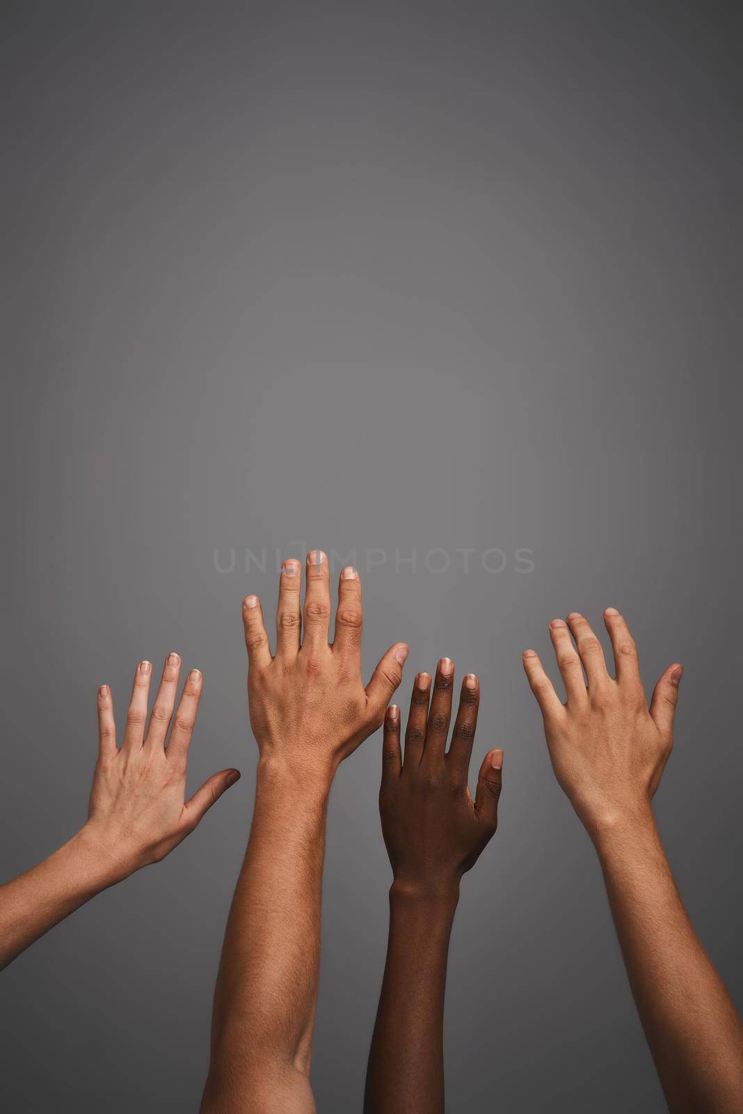 Raise your hand if you love blank copyspace. Studio shot of unidentifiable hands reaching up towards blank copyspace. by YuriArcurs