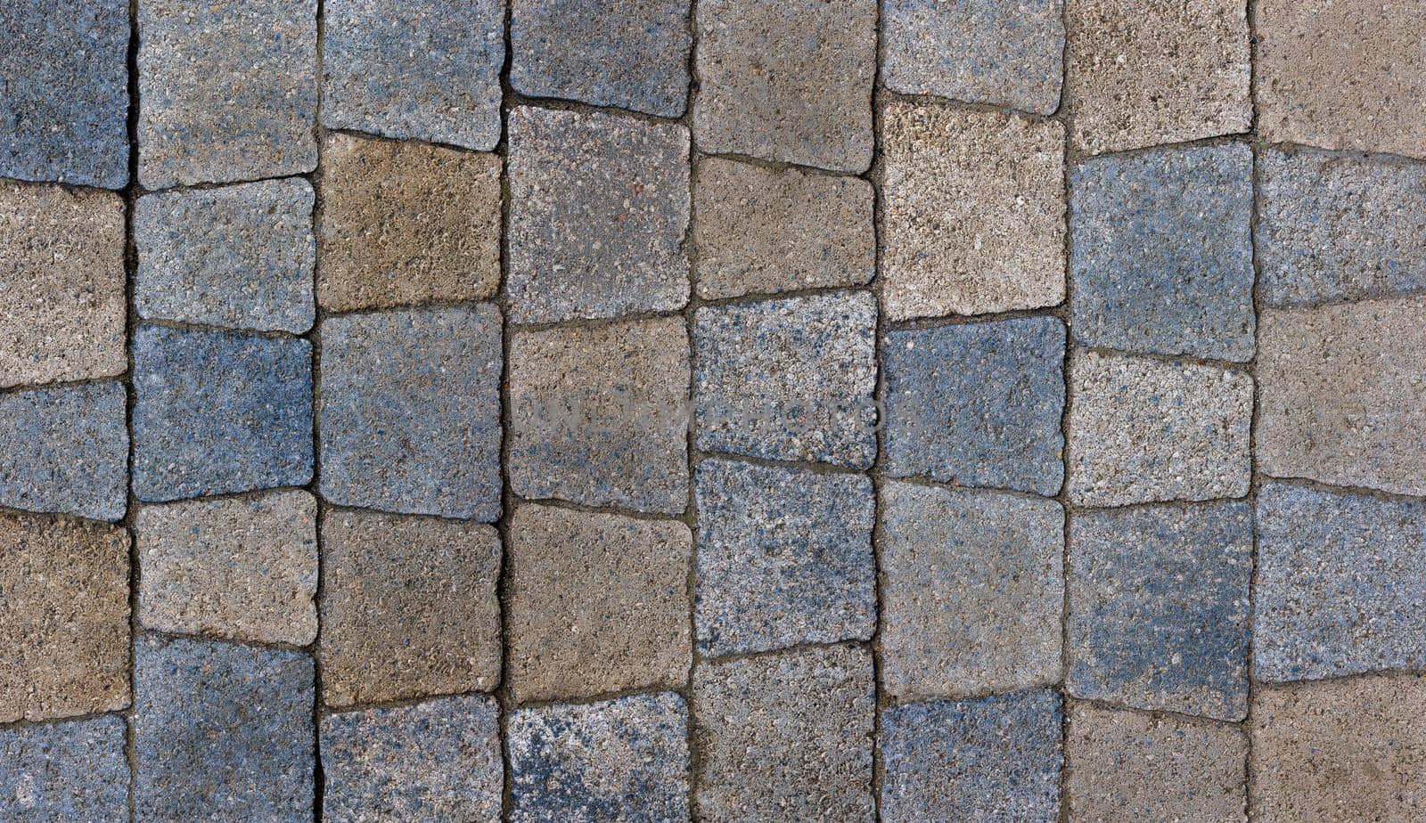 colored trapezoid concrete tiles pavement in high angle view - full frame background and texture.