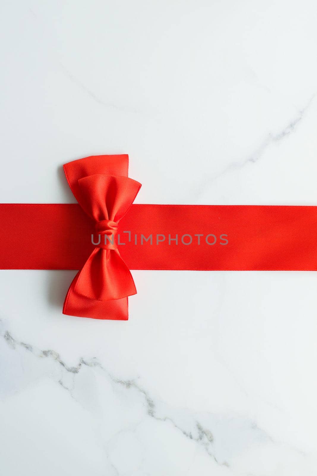 Holiday decor, feminine design and flatlay concept - Red silk ribbon on marble, top view