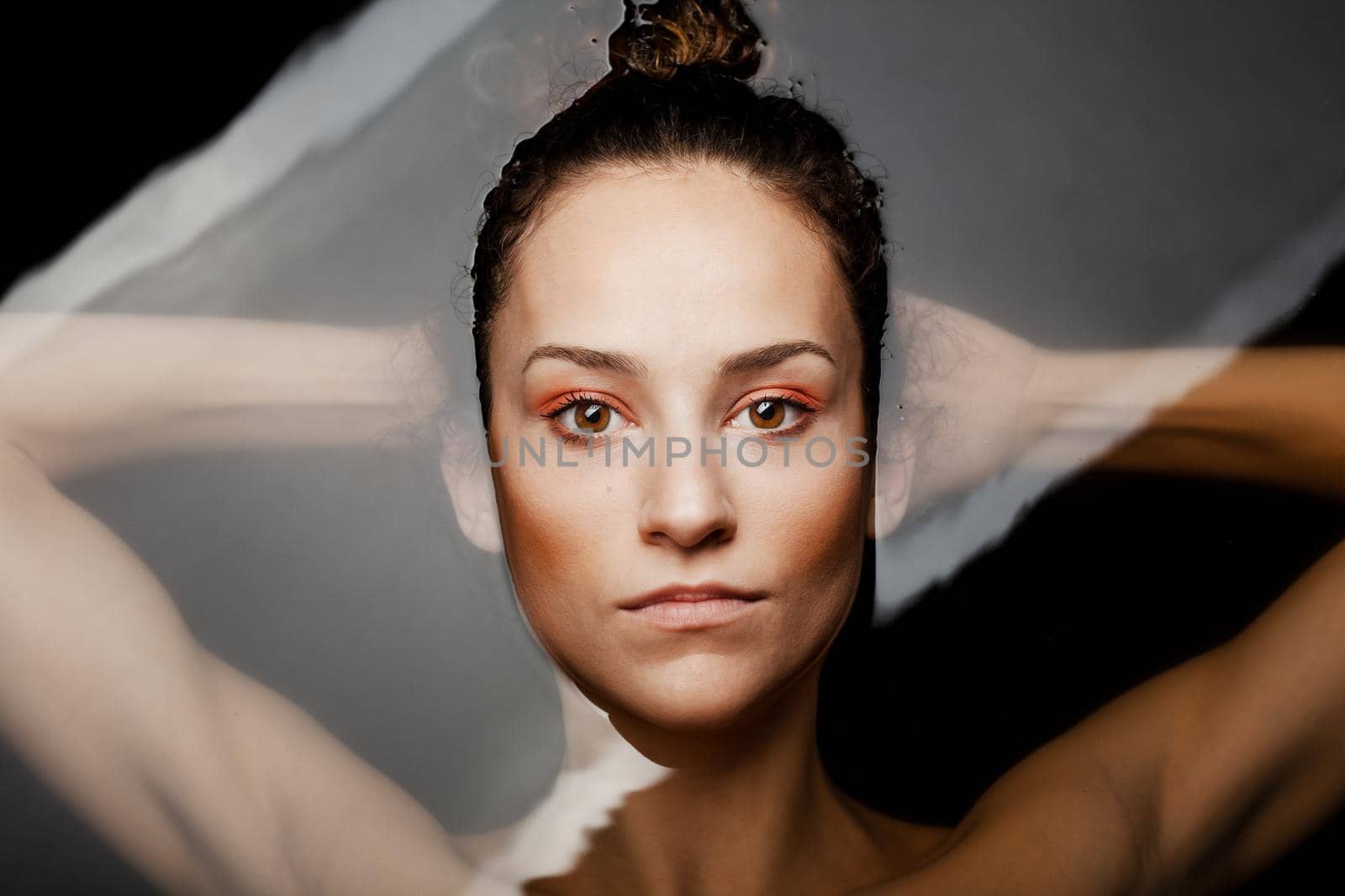 Underwater beauty portrait of a beautiful caucasian girl. Looking at camera.