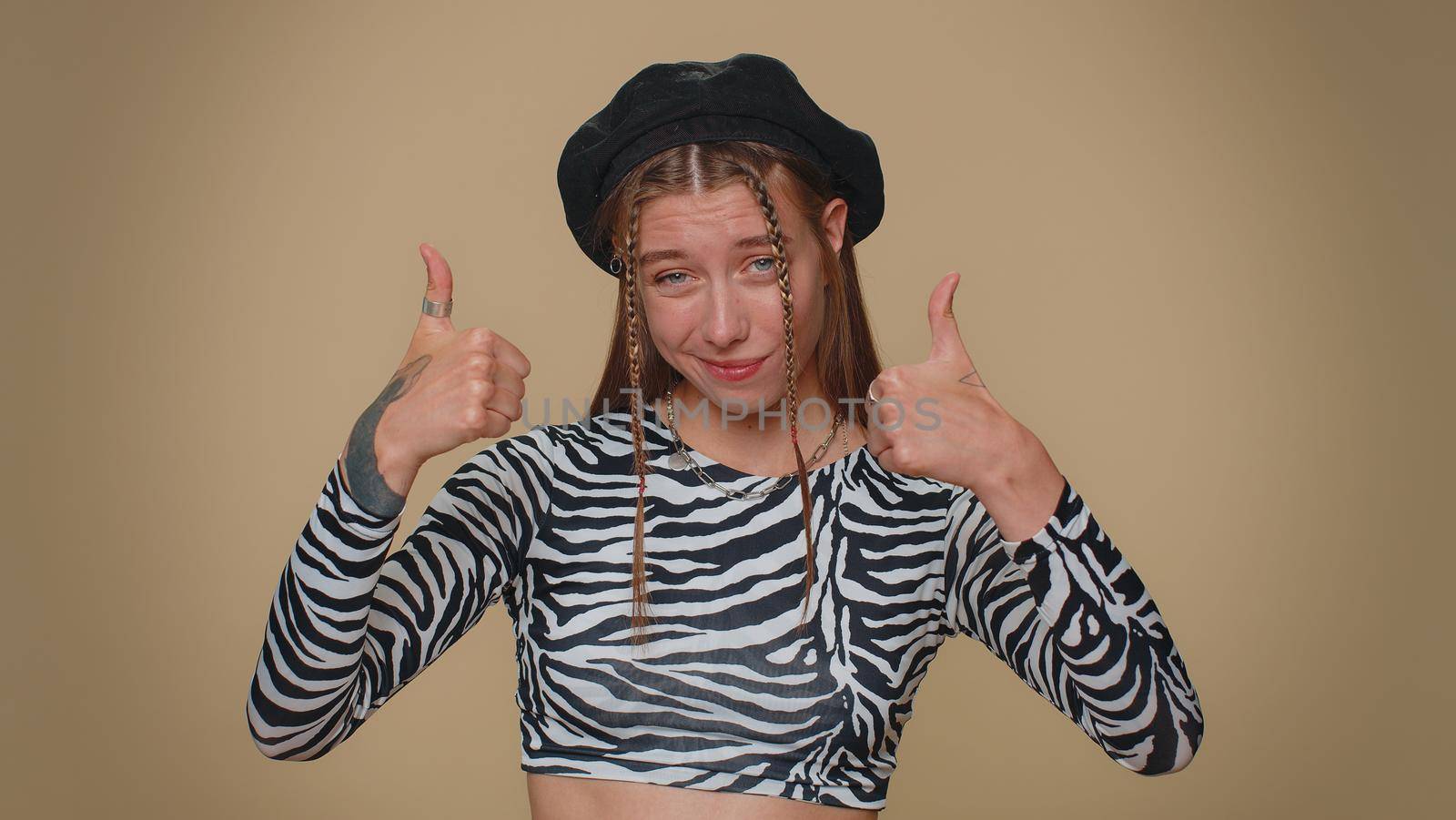 I am the best, choose me. Lovely pretty young woman in feeling very proud pointing herself, looking self-confident, overjoyed by success. Adult stylish girl isolated on beige studio background indoors