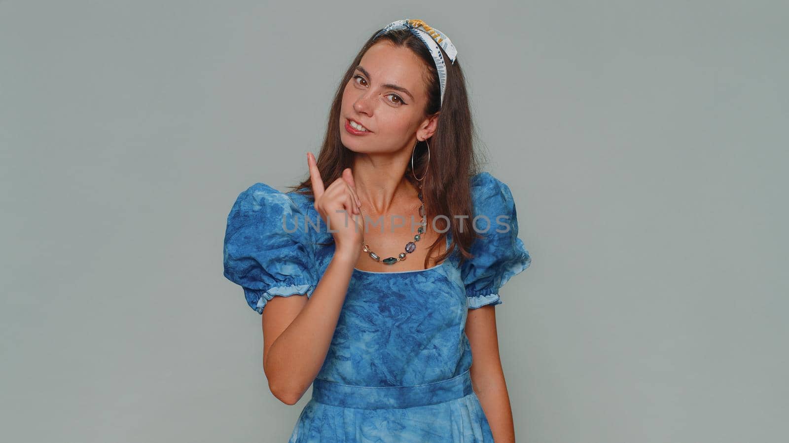 Quarrel. Displeased pretty young woman gesturing hands with irritation and displeasure, blaming scolding for failure, asking why this happened. Adult girl isolated on gray studio background indoors