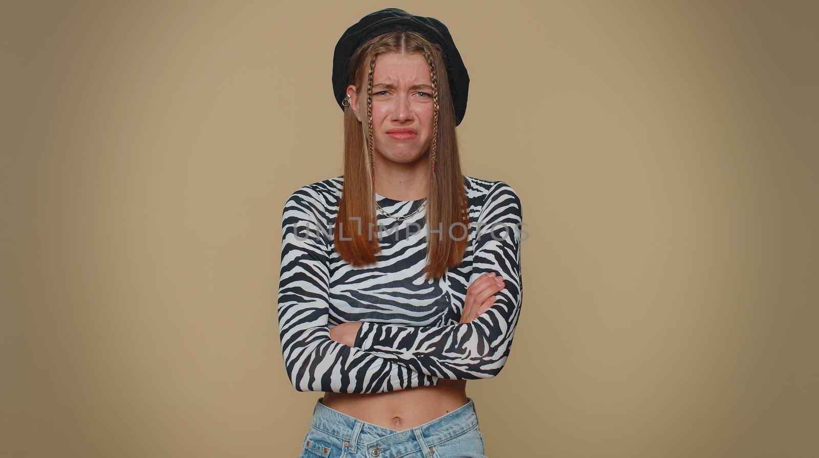 Dissatisfied pretty young woman asking reason of failure, expressing disbelief irritation, feeling bored, disappointed in result, bad news. Adult stylish girl isolated alone on beige studio background