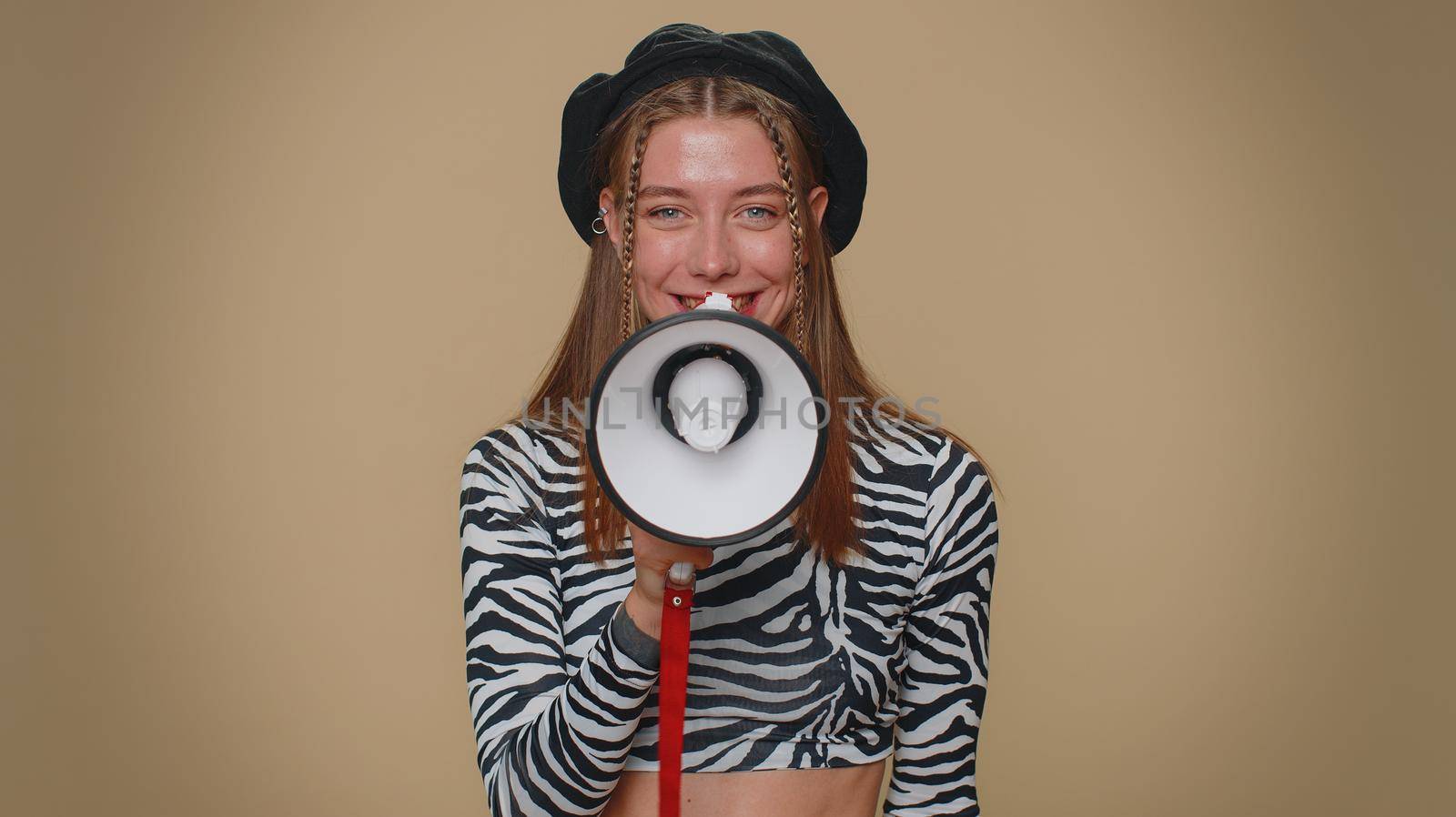 Pretty young woman talking with megaphone, proclaiming news, loudly announcing advertisement, warning using loudspeaker to shout speech. Girl scream in megaphone announces discounts sale Hurry up