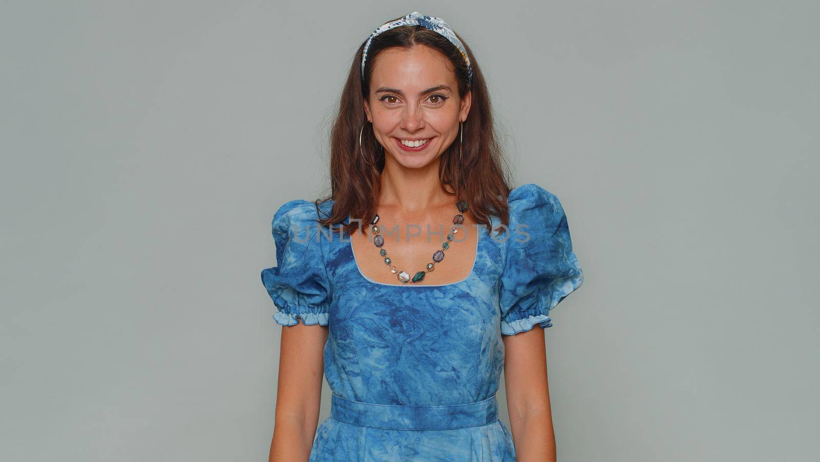 Lovely young woman laughing out loud after hearing ridiculous anecdote, funny joke, feeling carefree amused, positive people lifestyle. Adult stylish girl isolated on gray studio background indoors