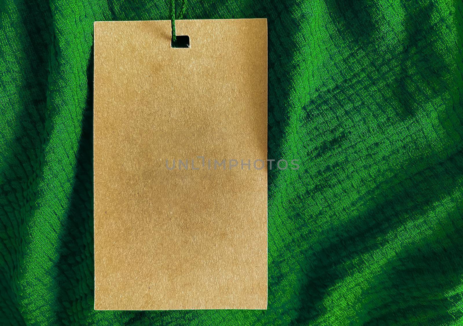 Blank fashion label tag, sale price card on luxury fabric background, shopping and retail concept