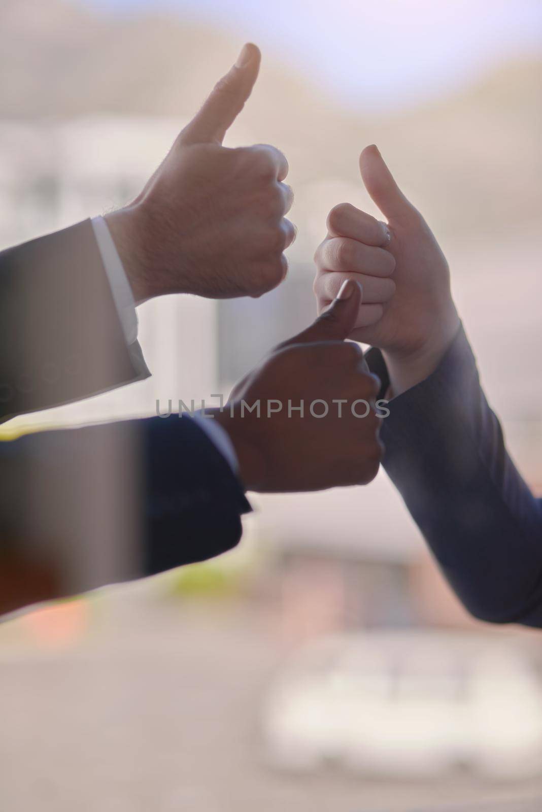 Approval across the baord. a group of businessmen showing a thumbs up gesture