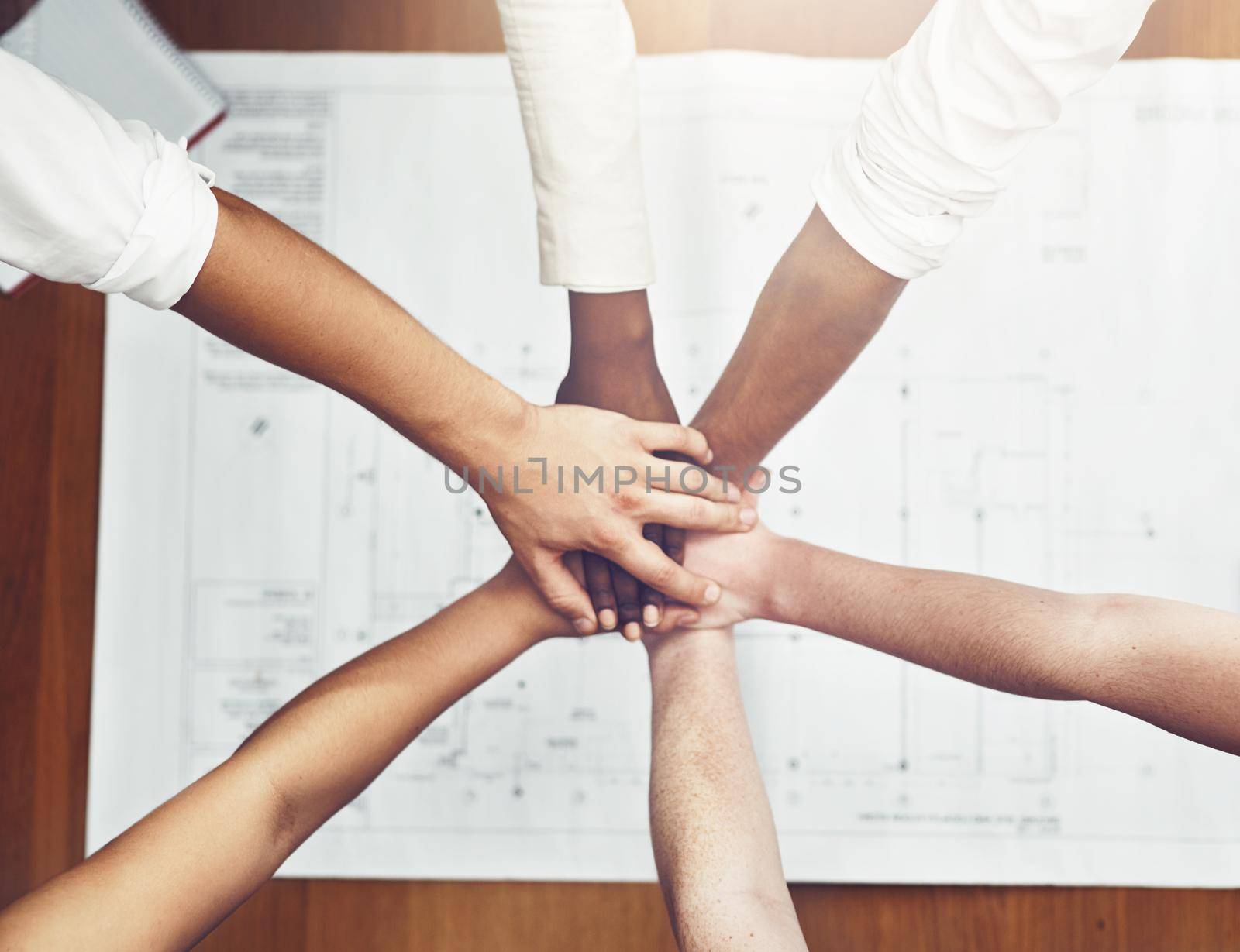 We always share the load. unrecognizable businesspeople joining their hands together in unity