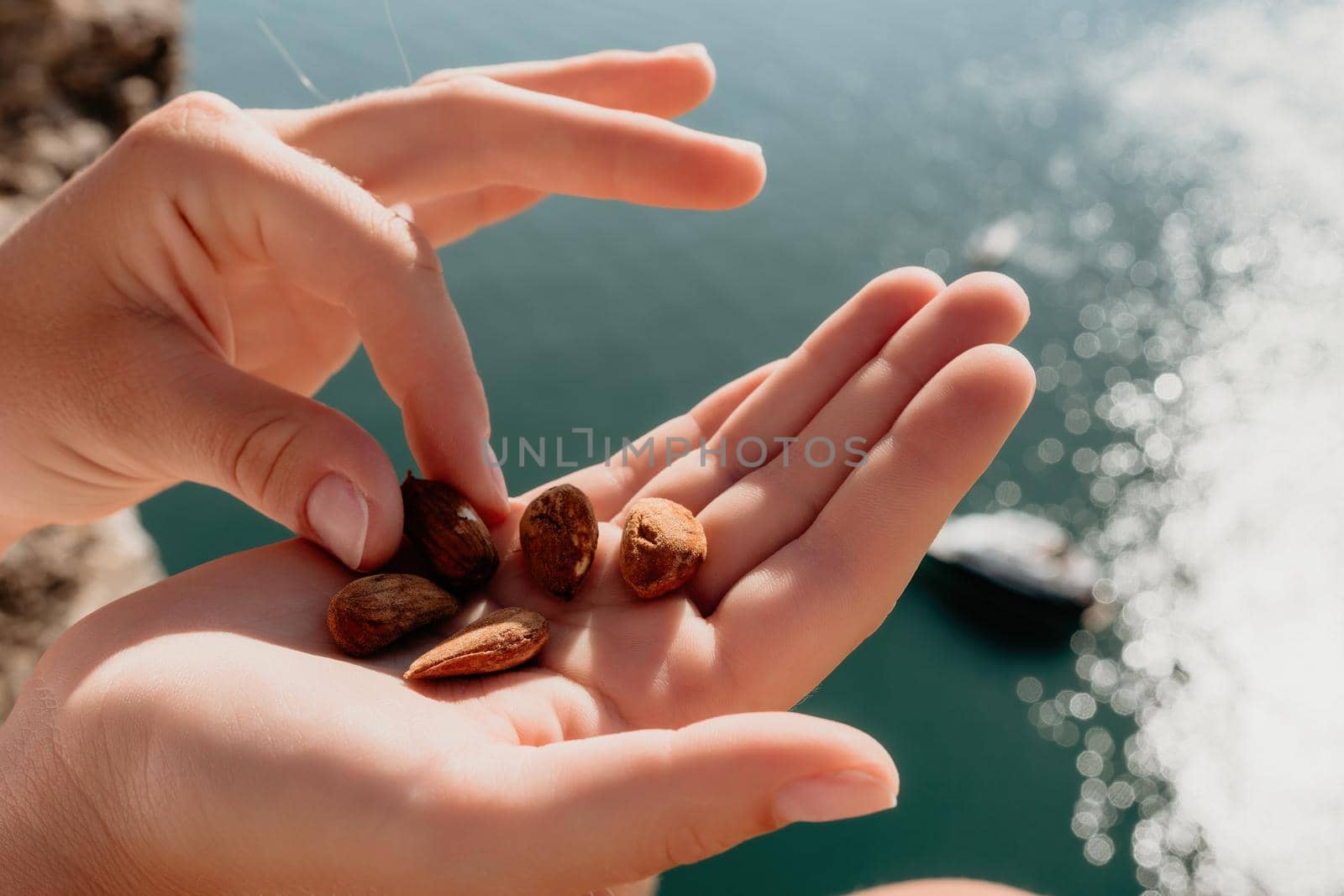 Unrecognizable caucasian woman eating young milky almond nuts. Healthy vegan food