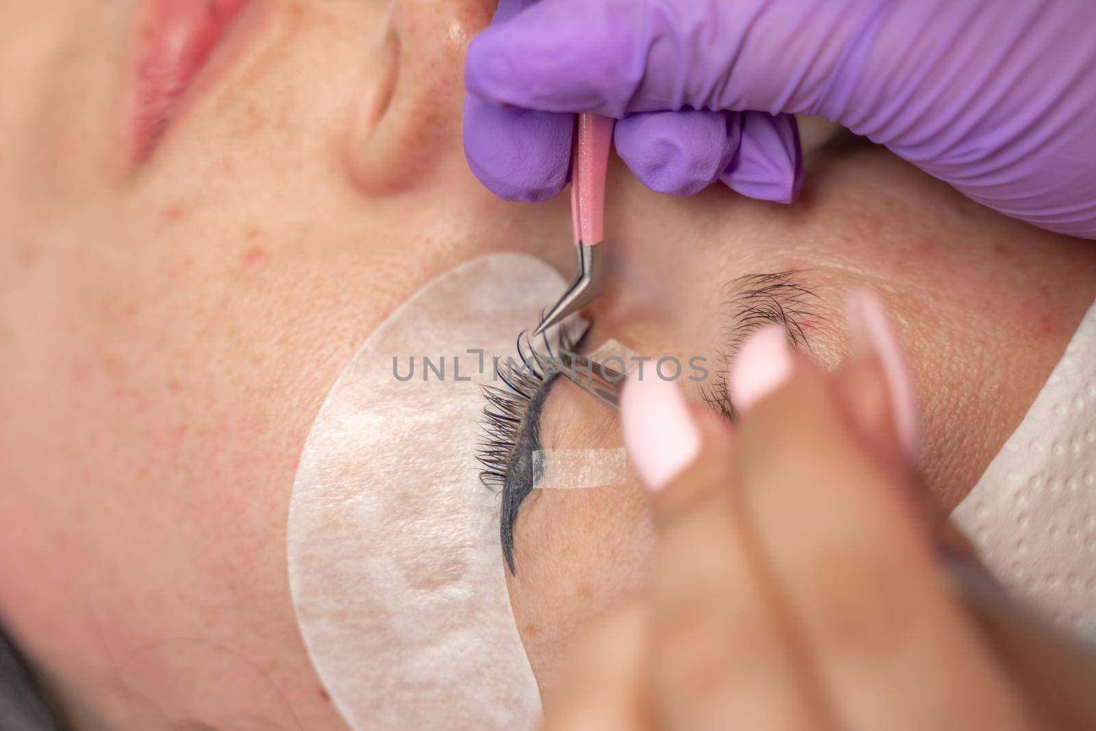 Eyelash extension procedure. Woman eye with long eyelashes. lashes, close up, macro, selective focus