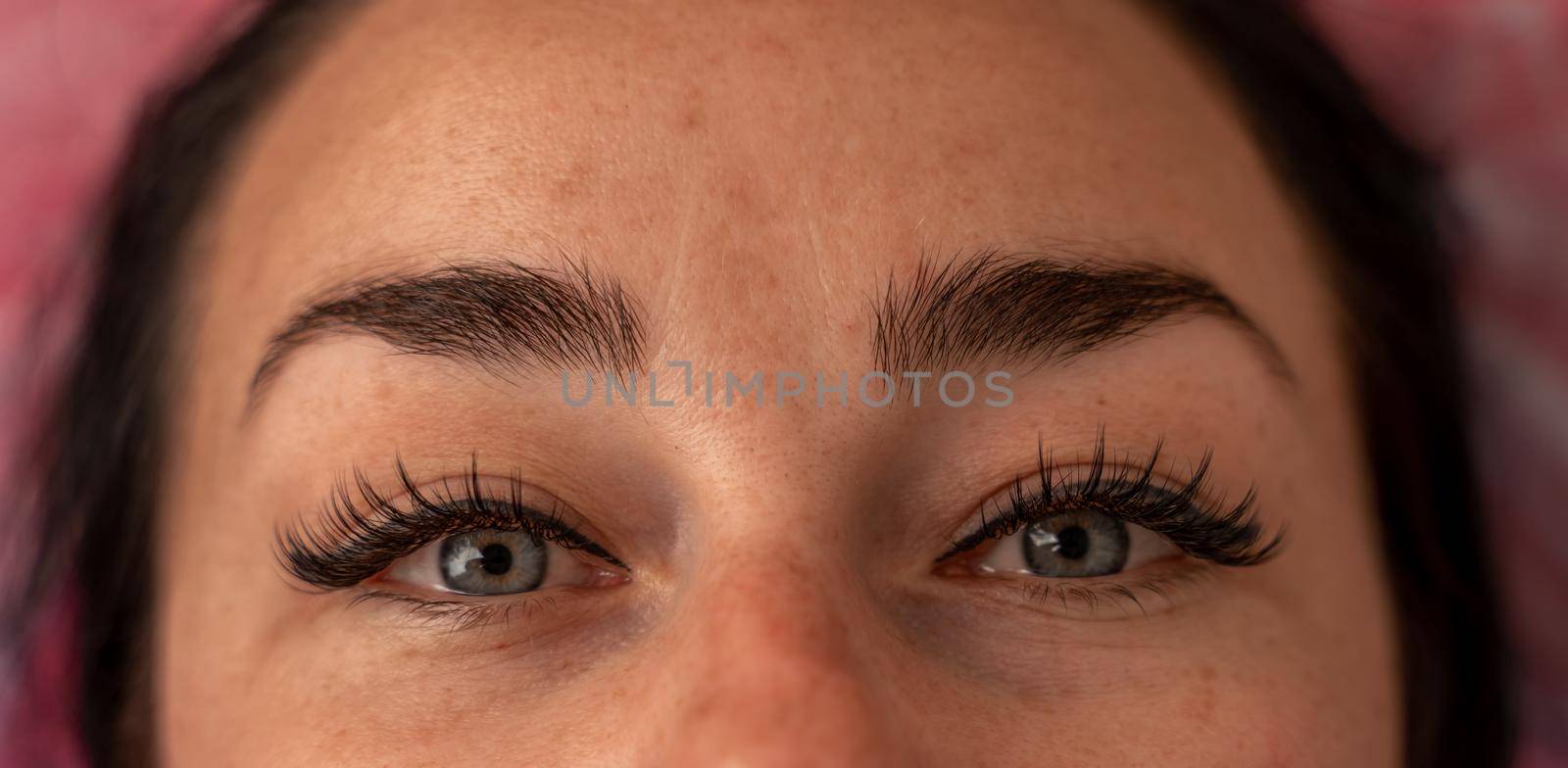 Eyelash extension procedure. Woman eye with long eyelashes. lashes, close up, macro, selective focus