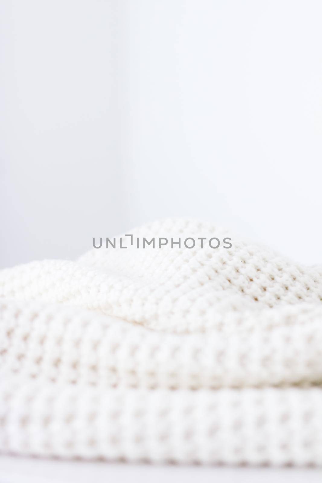 Knitwear, fabric textures and handmade items concept - Warm knitted clothes, soft and white