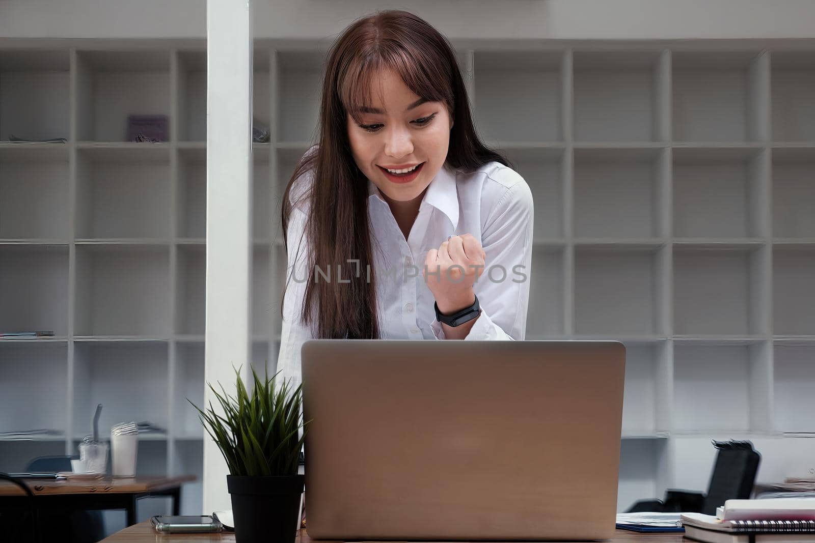 Cheerful young asian woman using laptop computer at home. Student female in living room. online learning, studying , online shopping, freelance, asean concept.