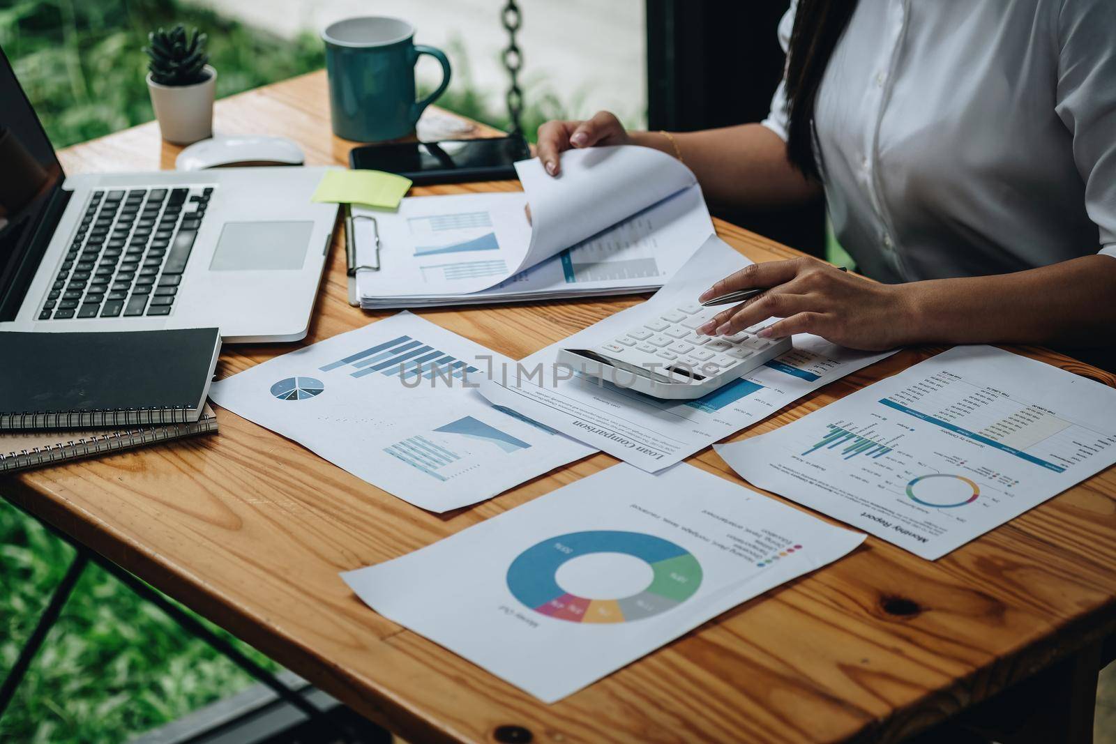 Close up woman calculating using machine managing household finances at home, focused biracial male make calculations on calculator paying bills, account taxes or expenses by nateemee