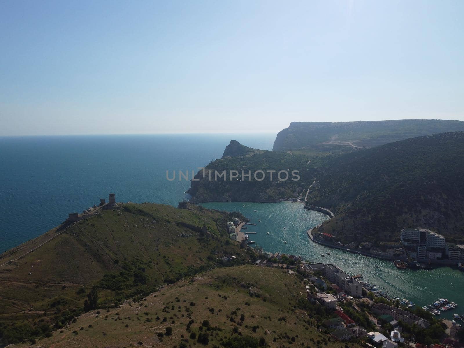 Aerial above Balaclava picturesque bay Crimea Sevastopol ancient resort city tourist attraction. Many yacht ships dock sail. Sea gulf of tectonic fault. Yachting on Black Sea coast film