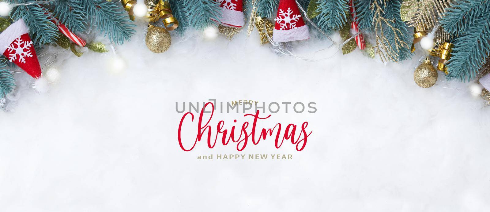 Banner with Merry Christmas text and fir branches Christmas decorations flat lay on a snowy background