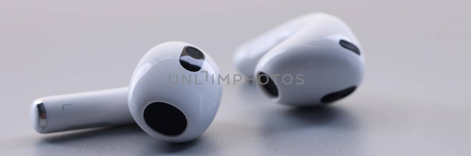 Closeup of new wireless headphones apple airpods 3 on white background by kuprevich