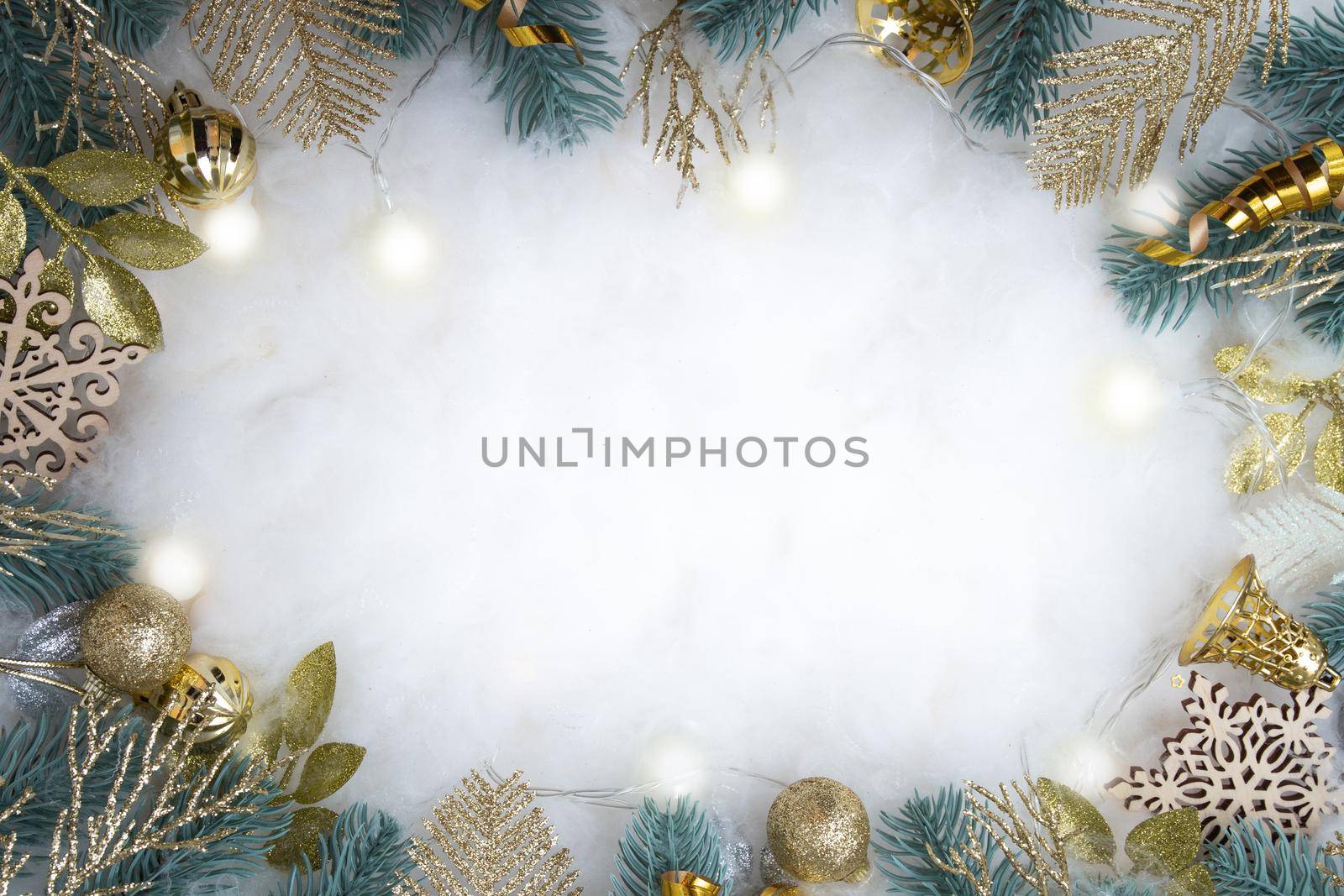 Frame made of Christmas decorations on a snowy background with copy space