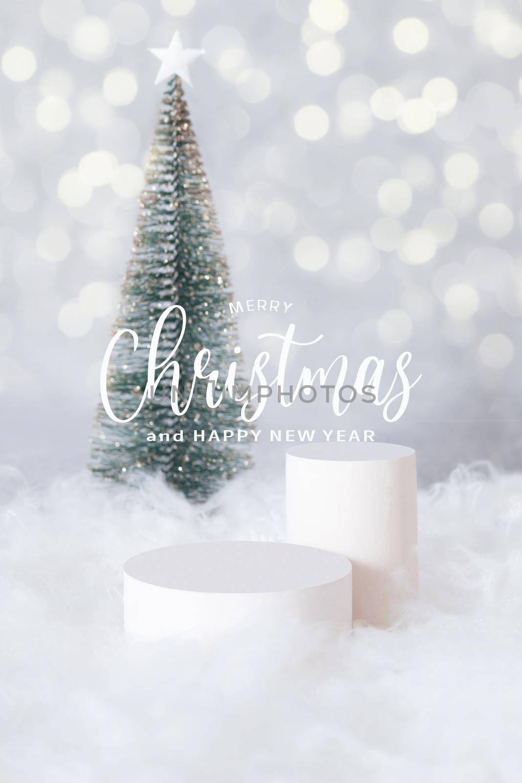 PMerry Christmas greetings and podium or pedestal in the snow with a christmas tree on a bokeh background vertical format