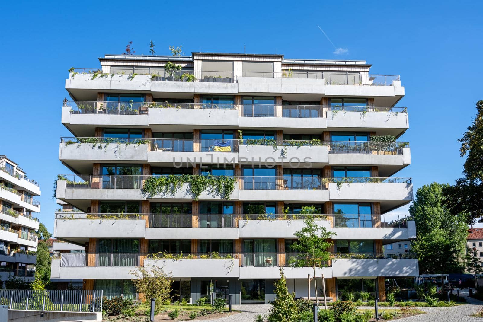 Modern grey apartment house on a sunny day by elxeneize