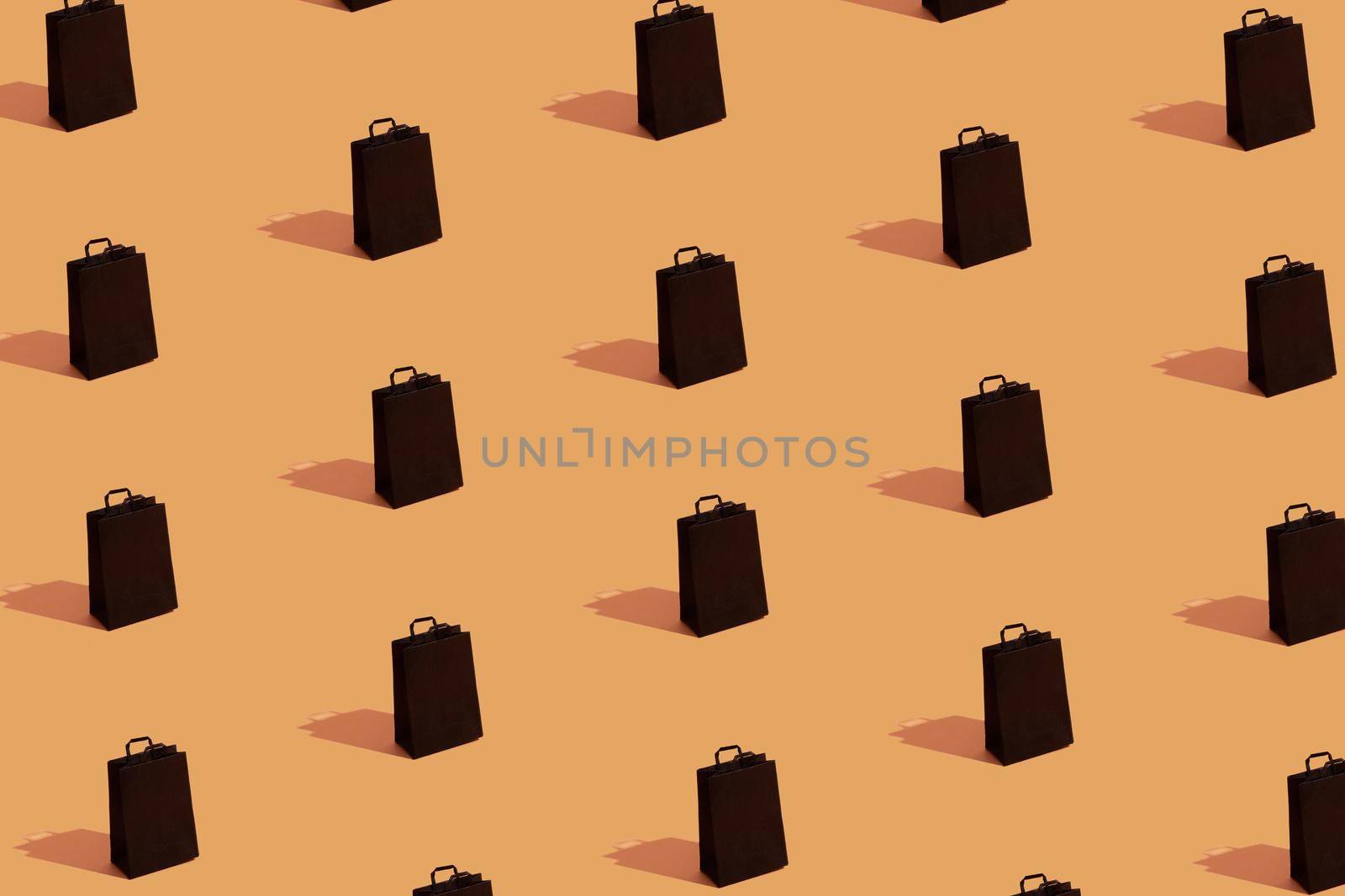 Pattern with black shopping bags sale on orange background