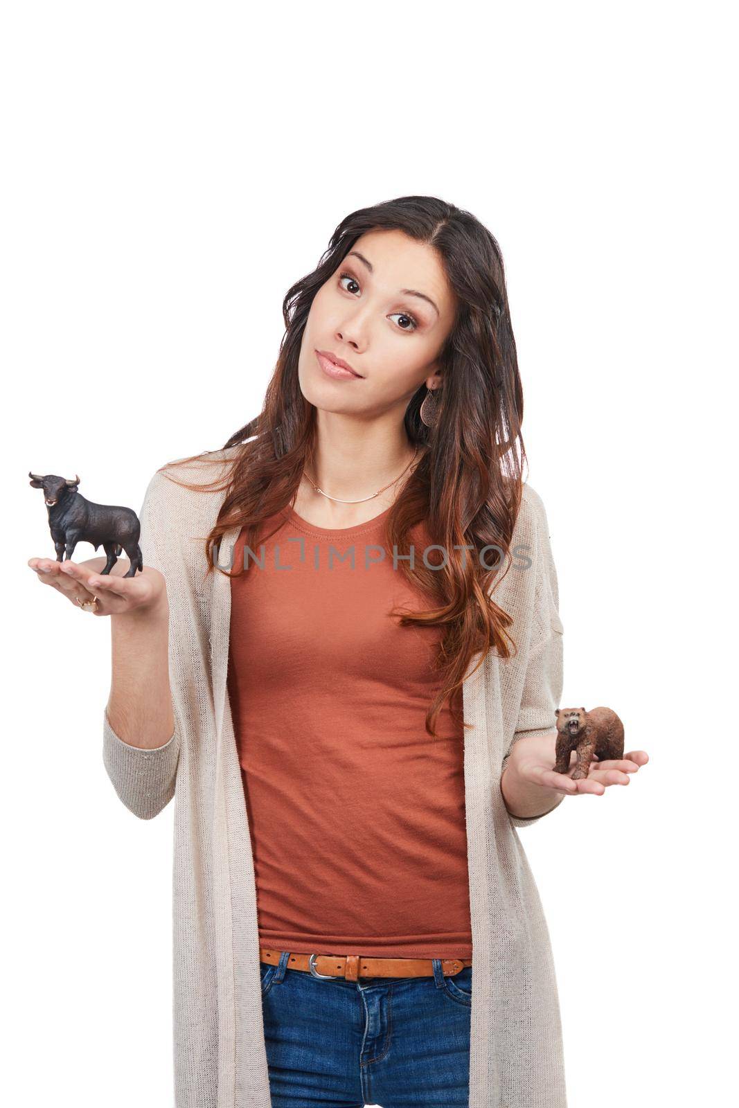 Weve all got a little animal in us. Portrait of a confident young woman holding up two toy animals in studio. by YuriArcurs