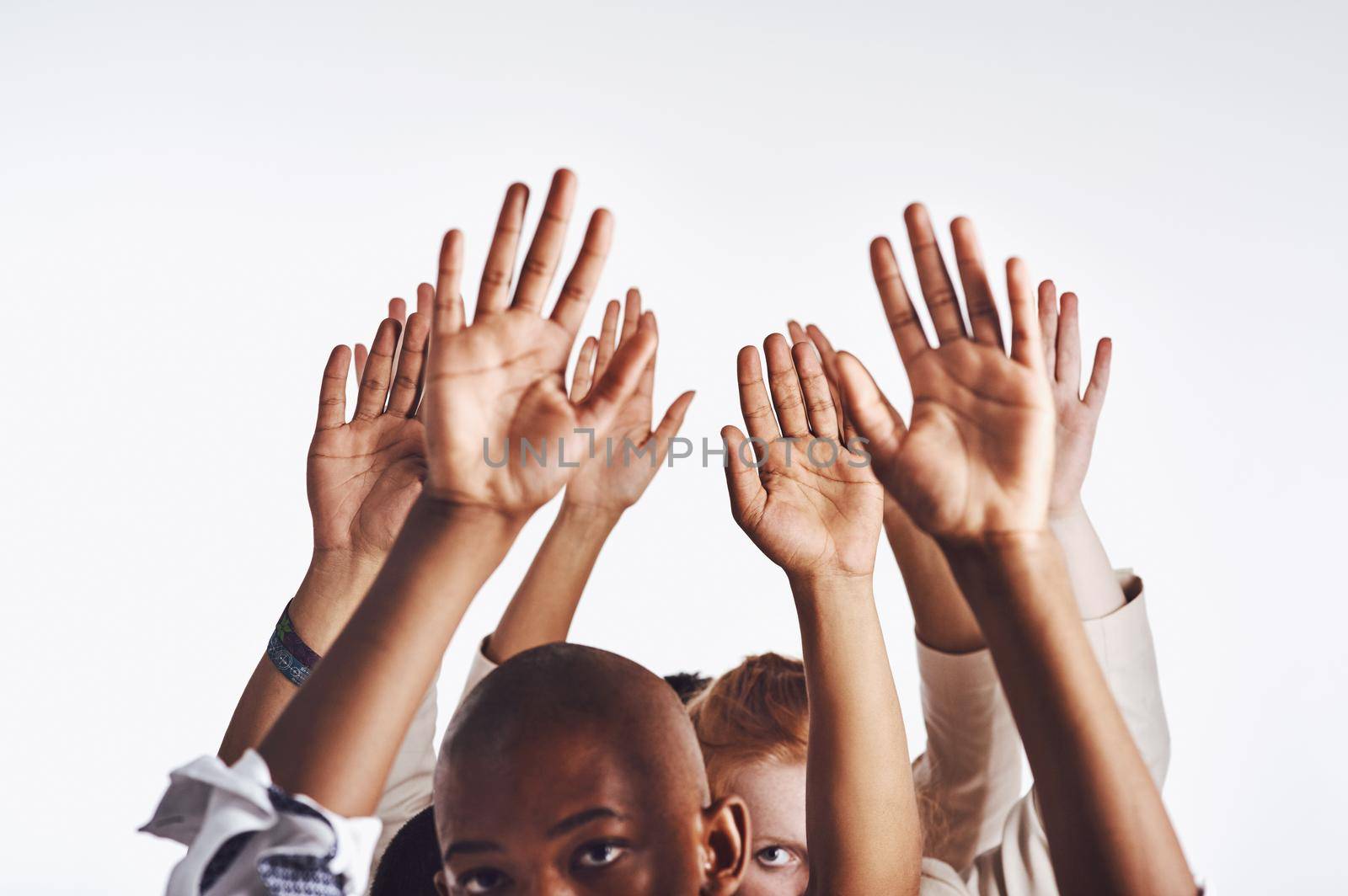 Sometimes you just have to accept your failure. a group of hands reaching up against a white background. by YuriArcurs