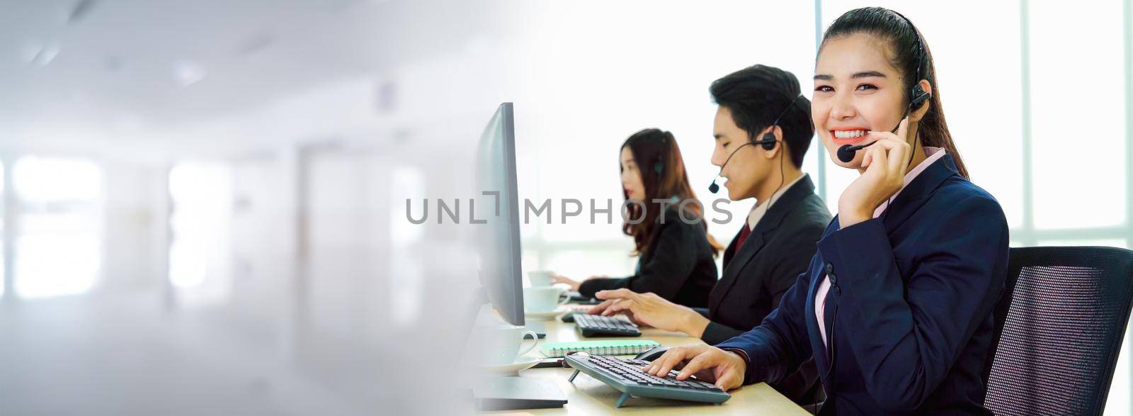 Business people wearing headset working in office in widen view to support remote customer or colleague. Call center, telemarketing, customer support agent provide service on telephone video call.