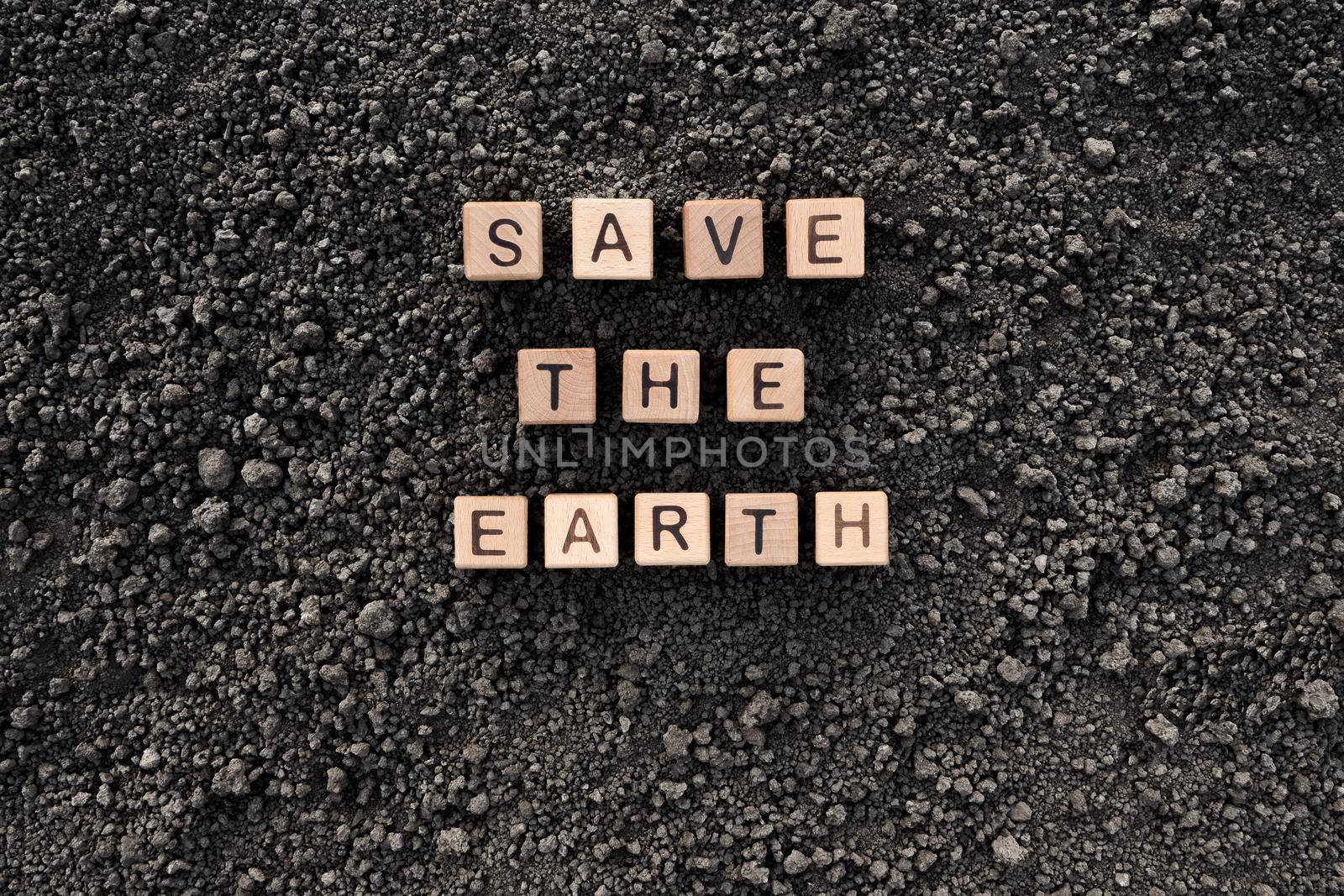 Letter block toy cube wood text Save the Earth word block wooden cubes concept world environment day. Black soil background earth day. Soil earth texture ground soil texture wooden block concept word